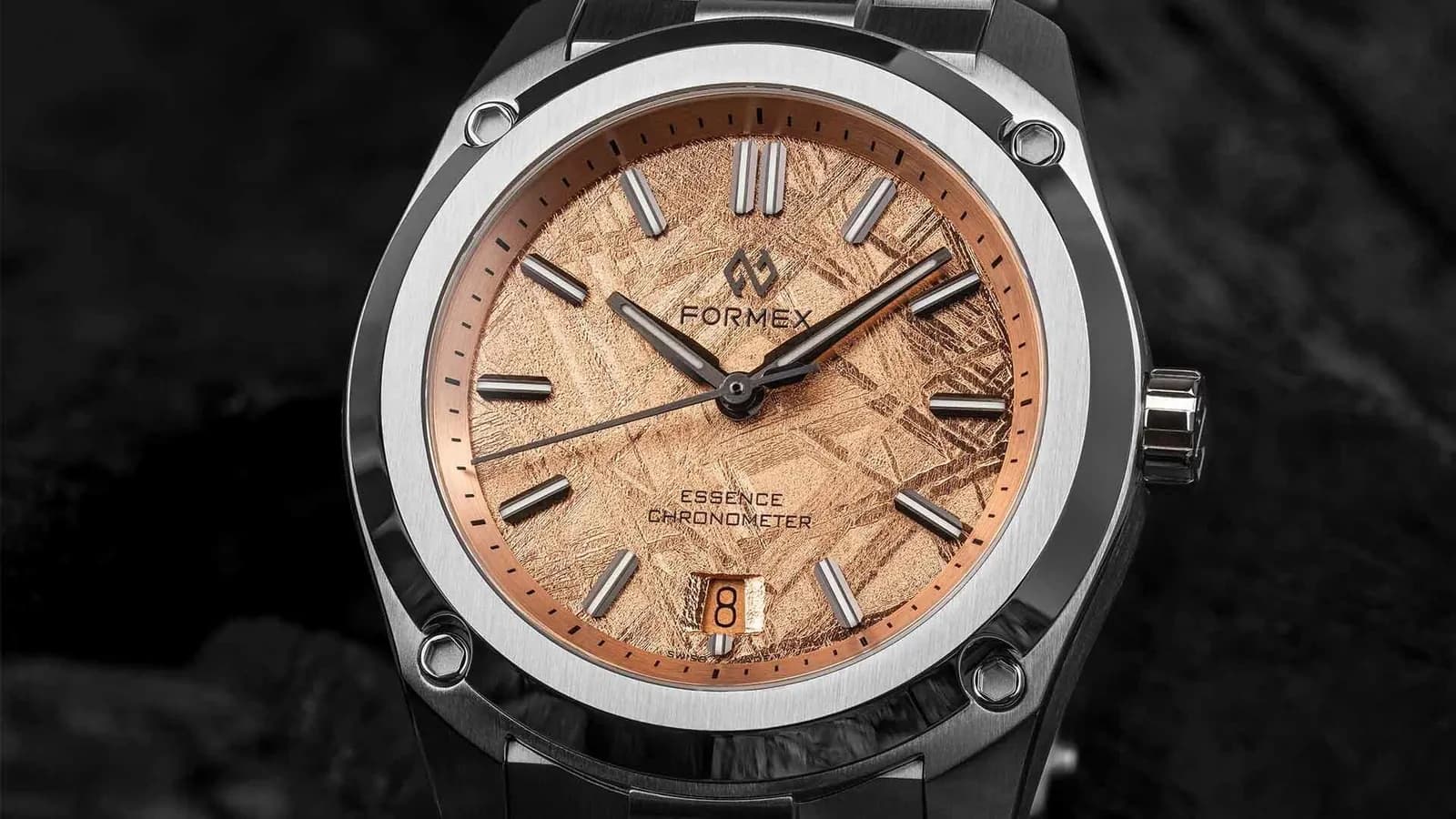 Formex Essence "Space Gold" close-up showing the detailed dial, case finishing, bracelet integration, and precision manufacturing behind a completed watch.
