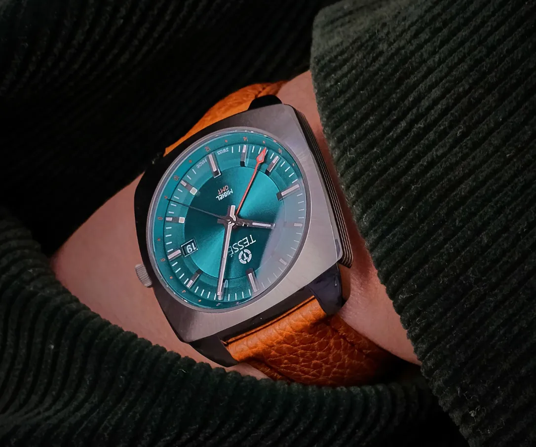 Tessé Michel GMT on the wrist, showing the brand's distinctive cushion-style case architecture, teal dial, and leather strap.